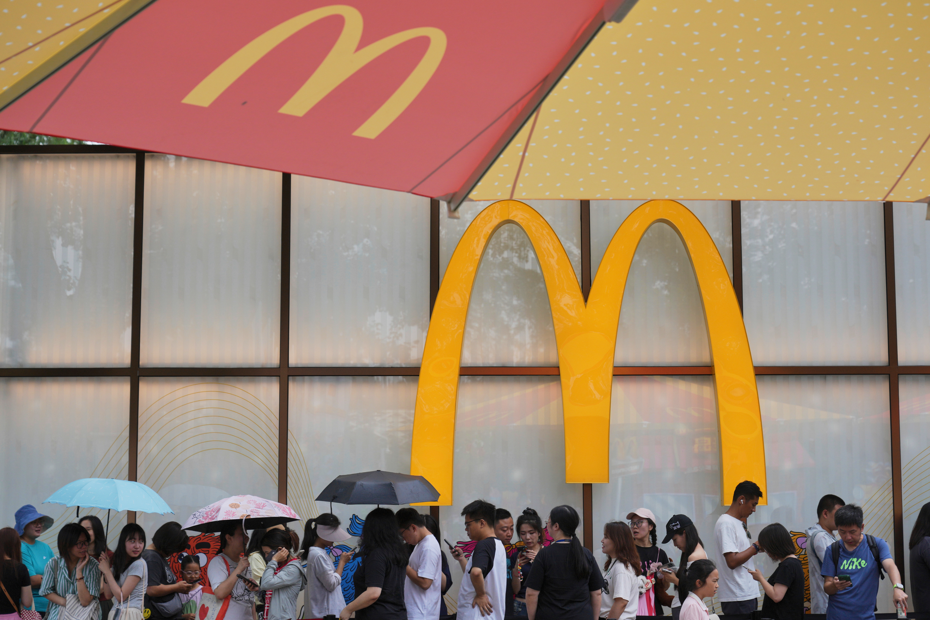 People line up to enter a McDonald's restaurant in Beijing, Aug. 20, 2025.