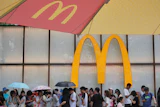 People line up to enter a McDonald's restaurant in Beijing, Aug. 20, 2025.