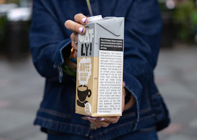 Oatly's Caroline Reid holds the company's new milk carton in New York, Sept. 23, 2026.