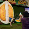 A customer poses beside a giant durian display, Petaling Jaya, Malaysia, June 22, 2026.