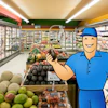 Friendly grocery store worker in blue uniform smiling in supermarket aisle with refrigerated cases and fresh produce displays