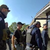 This image from Homeland Security Investigations body camera video shows federal authorities entering the Nutrition Bar Confectioners plant in Cato, N.Y., Sept. 4, 2025.