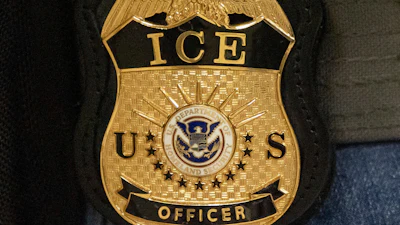 A federal agent wears an Immigration and Customs Enforcement badge in New York, June 10, 2025.