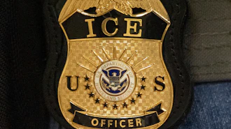 A federal agent wears an Immigration and Customs Enforcement badge in New York, June 10, 2025.