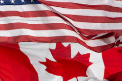 United States and Canadian flags overlapping, showing red and white stripes with stars and maple leaf symbols