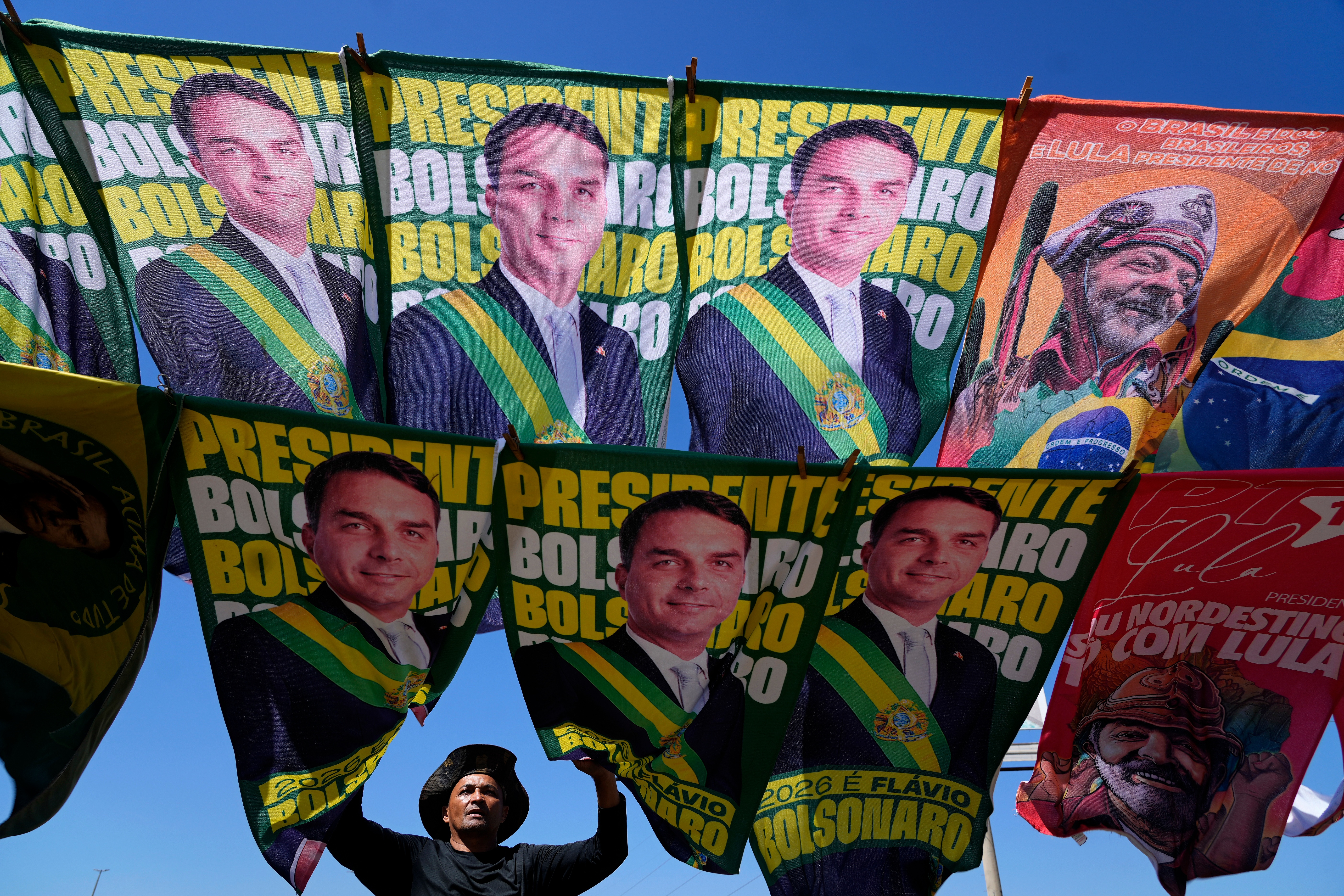 A street vendor sells campaign flags of presidential candidates Sen. Flavio Bolsonaro and current President Luiz Inacio Lula da Silva, Brasilia, Brazil, Sept. 29, 2026.