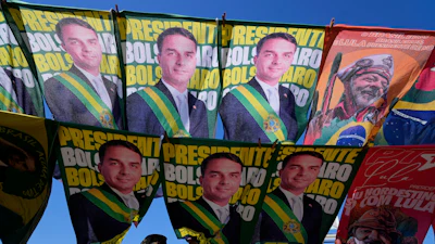 A street vendor sells campaign flags of presidential candidates Sen. Flavio Bolsonaro and current President Luiz Inacio Lula da Silva, Brasilia, Brazil, Sept. 29, 2026.