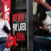 A woman walks by a 'Buy now pay later' sign at a store in Bangalore, India, Sept. 10, 2009.
