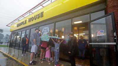 Luke Churchill, left, stands with his wife Mary and their children Katie, Liam and Raighan outside a Waffle House restaurant in Wilmington, N.C., Sept. 16, 2018.