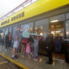 Luke Churchill, left, stands with his wife Mary and their children Katie, Liam and Raighan outside a Waffle House restaurant in Wilmington, N.C., Sept. 16, 2018.