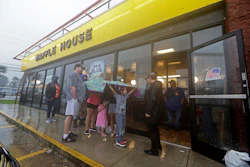 Luke Churchill, left, stands with his wife Mary and their children Katie, Liam and Raighan outside a Waffle House restaurant in Wilmington, N.C., Sept. 16, 2018.