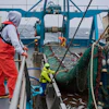 Crew members haul in a catch aboard the F/V Progress in the Bering Sea off the coast of Alaska, July 22, 2026.