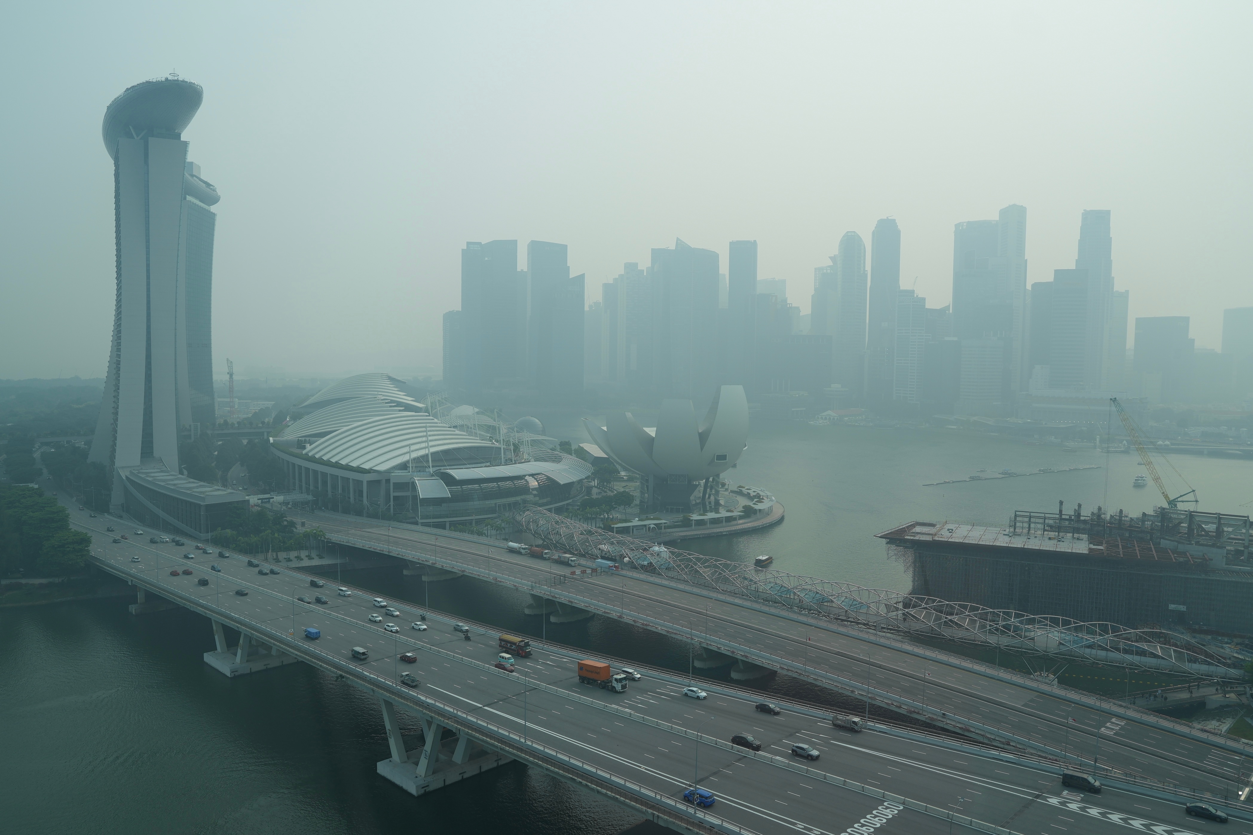 A thick haze obscures the skyline behind the Central Business District area in Singapore, Oct. 9, 2026.