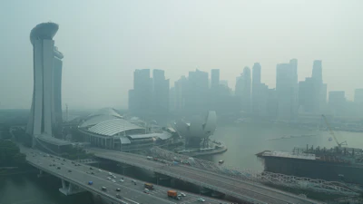 A thick haze obscures the skyline behind the Central Business District area in Singapore, Oct. 9, 2026.