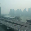 A thick haze obscures the skyline behind the Central Business District area in Singapore, Oct. 9, 2026.