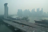 A thick haze obscures the skyline behind the Central Business District area in Singapore, Oct. 9, 2026.