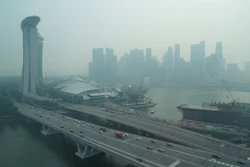 A thick haze obscures the skyline behind the Central Business District area in Singapore, Oct. 9, 2026.