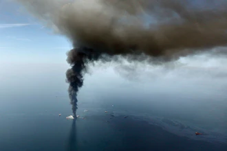 A large plume of smoke rises from BP's Deepwater Horizon offshore oil rig in the Gulf of Mexico on April 21, 2010.