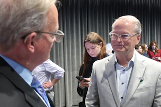 Democratic Senate nominee Adam Hamilton, right, speaks with Curtis Sneden, president and CEO of the Metropolitan Topeka Airport Authority, Oct. 16, 2026, Topeka, Kan.