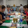 Nuria Isanda, 75, third from left, teaches tourists how to prepare and present traditional Spanish dishes during a cooking workshop at Grandmas Cooking in Barcelona, Oct. 14, 2026.