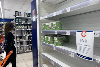A notice on empty shelves at a supermarket apologizes to customers for the lack of products, Naples, Italy, Oct. 20, 2026.