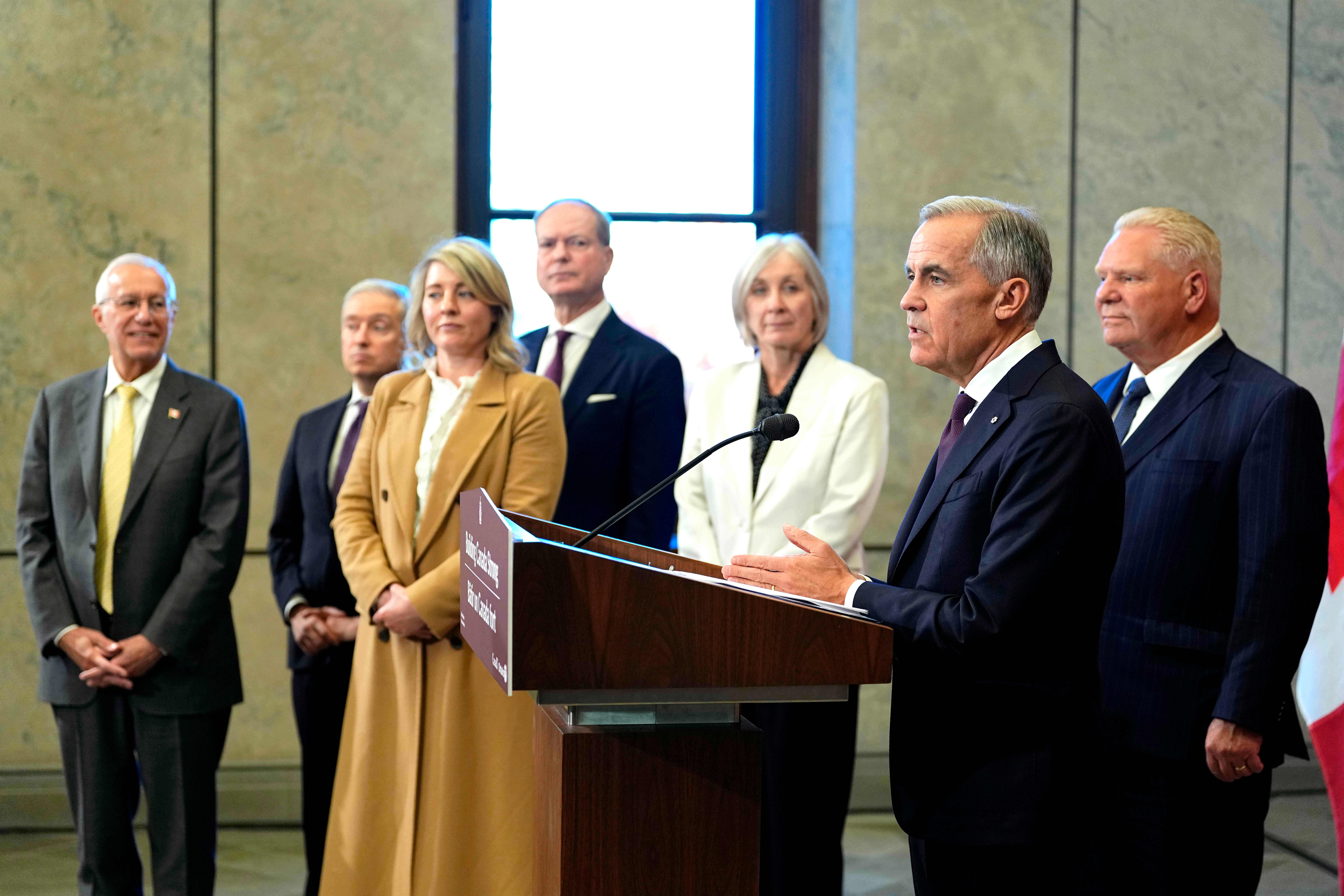 Canada Prime Minister Mark Carney and Ontario Premier Doug Ford, right, are joined by federal and provincial ministers at a joint news conference on Parliament Hill in Ottawa, Oct. 21, 2026.