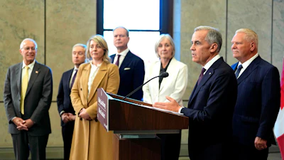 Canada Prime Minister Mark Carney and Ontario Premier Doug Ford, right, are joined by federal and provincial ministers at a joint news conference on Parliament Hill in Ottawa, Oct. 21, 2026.