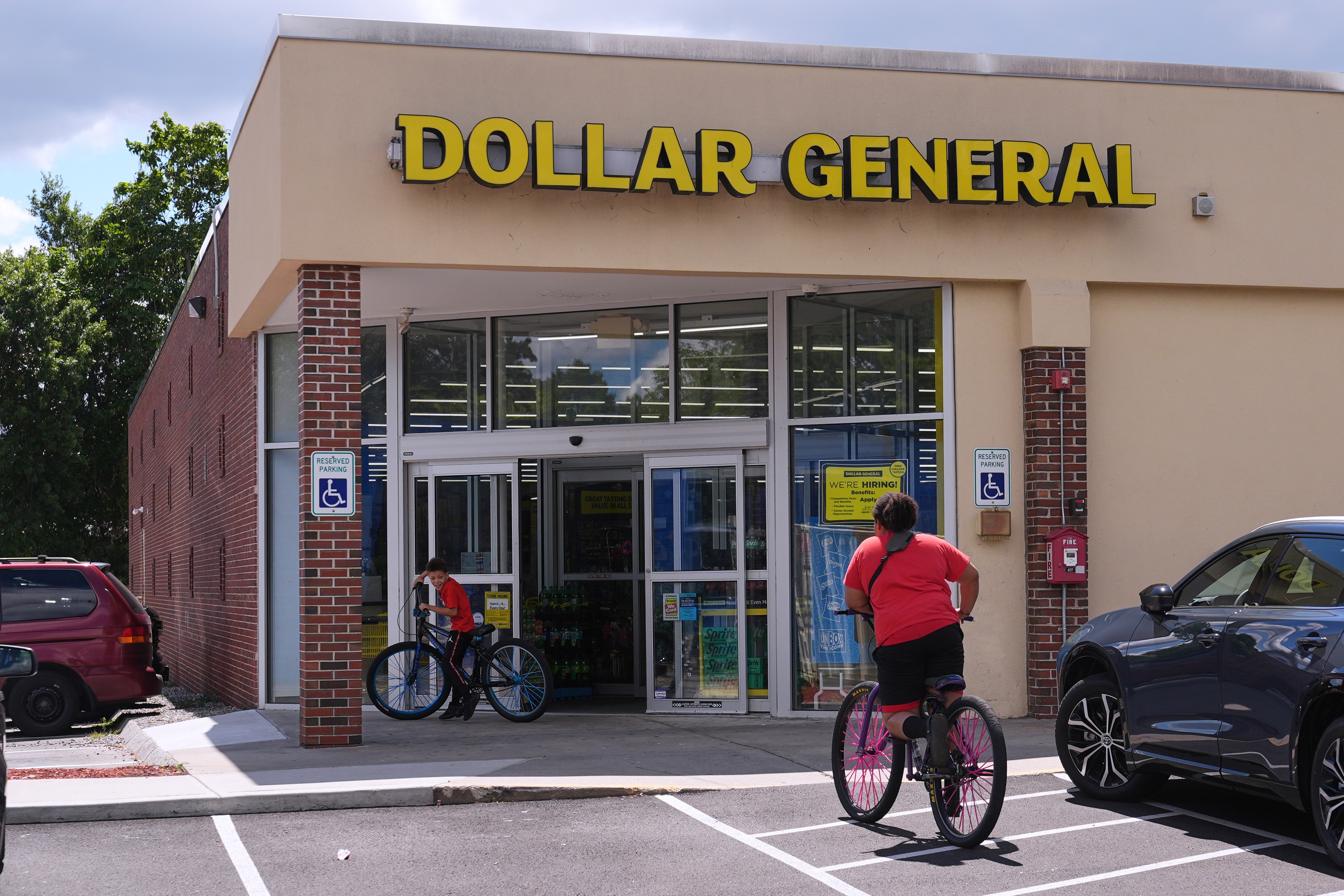 Children ride their bicycles to the Dollar General store, Aug. 21, 2025, Nashua, N.H.