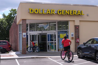 Children ride their bicycles to the Dollar General store, Aug. 21, 2025, Nashua, N.H.