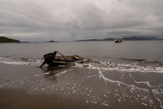 Daniel Arturo Caniullan Huentel, leader of the Indigenous Mapuche Pu Wapi community and a shellfish fisher, pushes a boat into the water before rowing out to his fishing boat in the Guaitecas Archipelago, Chile, May 22, 2025.