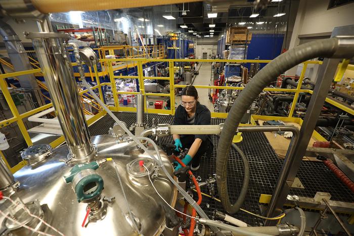 A staff member at the Integrated Bioprocessing Research Laboratory, University of Ilinois Urbana-Champaign, works at the argest precision fermentation tank.