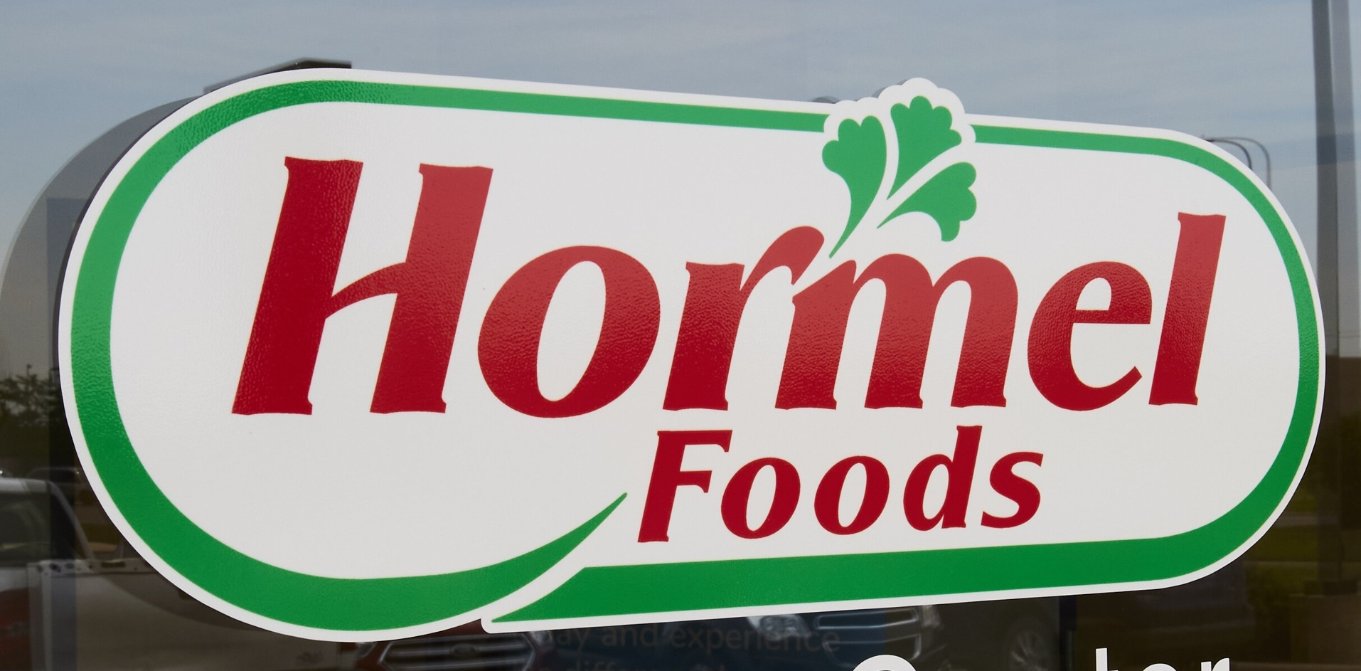 Hormel Foods storefront sign with red text and green decorative border featuring parsley leaf icon
