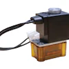 Industrial solenoid valve with black coil housing, amber transparent body, and attached power cable